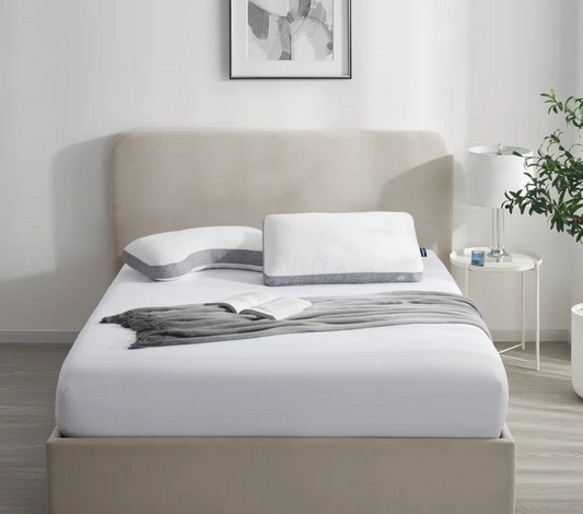 a bed with pillows and a blanket on it